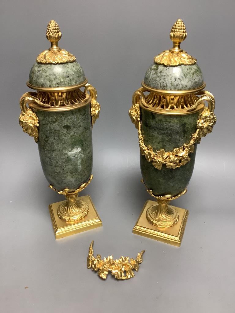 A modern pair of gilt metal and marble urns 32cm